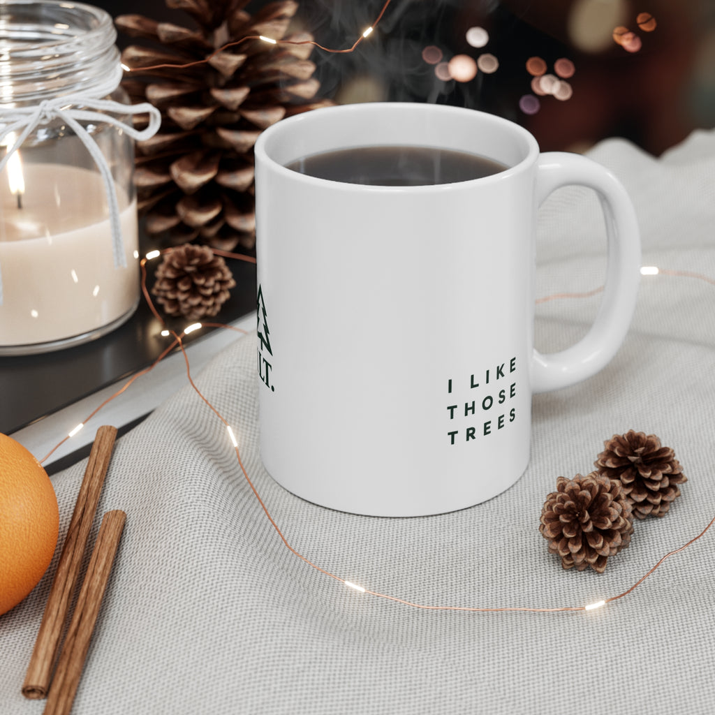 ILT Classic Mug lifestyle shot with coffee and pine cones, 11 oz white ceramic mug